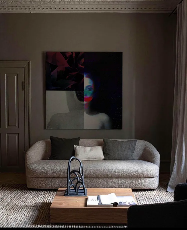 Collage featuring 3 pieces. A purple garden, the shoulder of a woman and half body of another woman with the face blurred in blue and red. The art its in the middle of a beautifull living room with a white sofa and a wood table