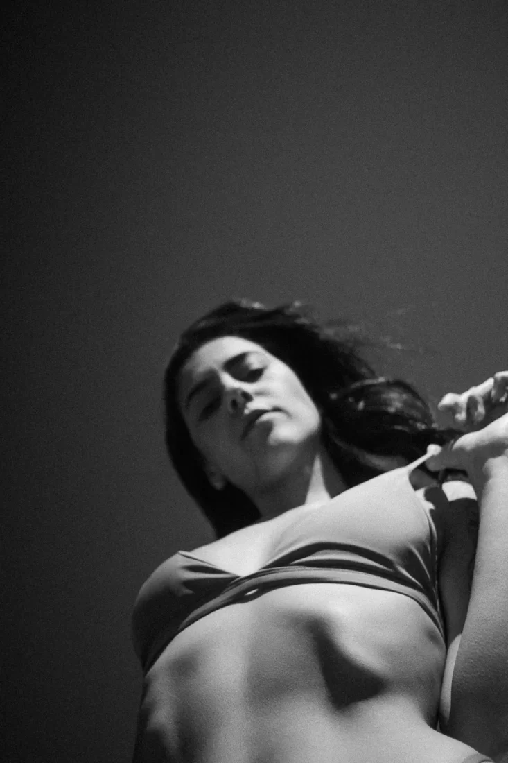 A woman shot from below. A little bit blurred and a lot of grain. Strange pic, shot on black and white