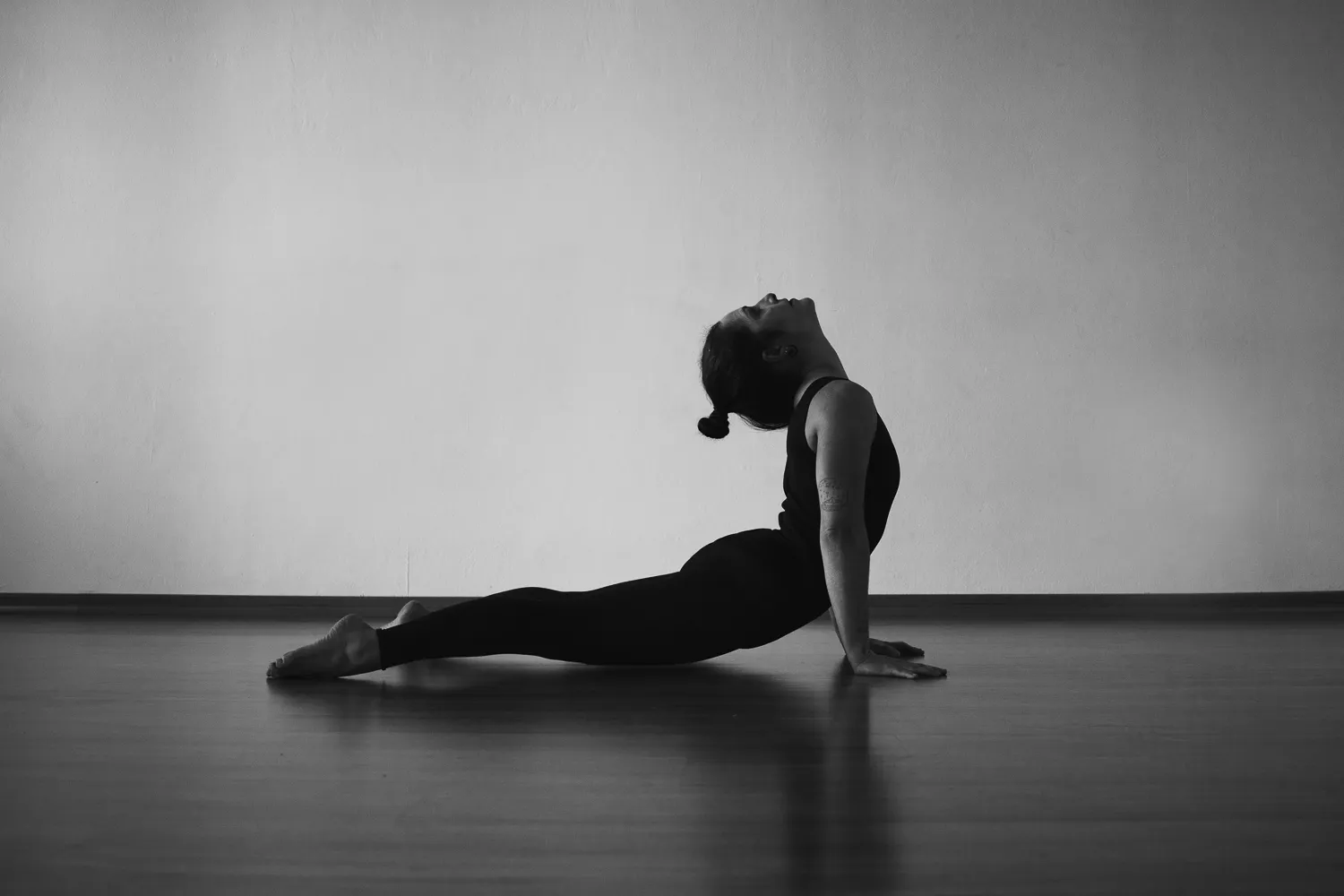 front image of a woman stretching herself shot on black and white