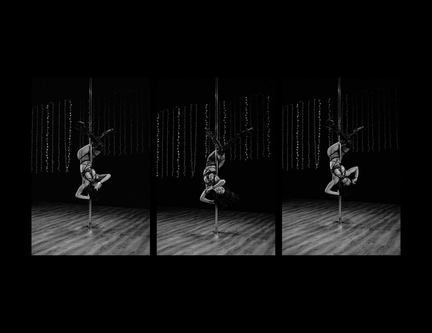 Black and White Pole Dance Portrait – Intimate Studio Photography by Rodrigo Baumgratz This black and white photograph by Rodrigo Baumgratz captures a powerful moment of pole dance performance. Suspended upside down with fluid strength, the performer is framed by a minimalist studio environment adorned with delicate vertical string lights. The high-contrast lighting emphasizes movement, texture, and body control, offering a striking visual of empowerment and grace. This image is ideal for portfolios focused on dance photography, performance art, studio portraiture, and gendered expression through movement. Keywords: pole dance photography, studio portrait, black and white dance image, Rodrigo Baumgratz, performance art photo, strength and grace.