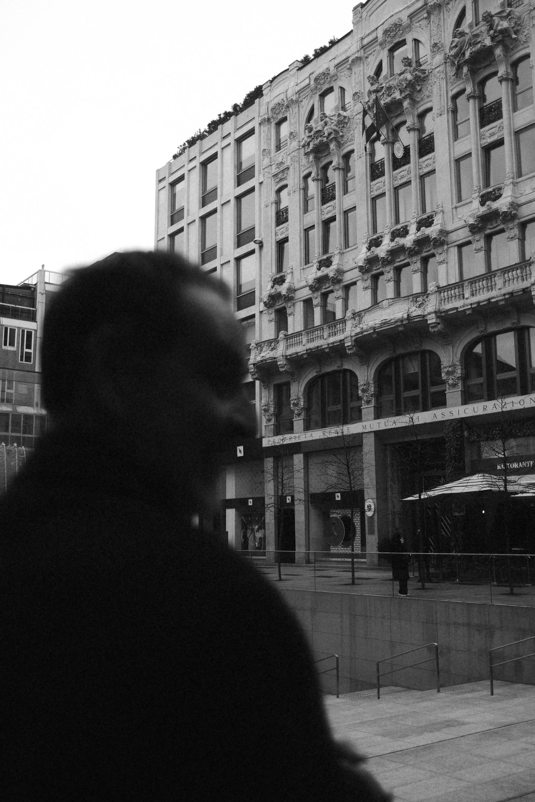 Silhouete of a man with the Duomo Piazza in the background. Milan.