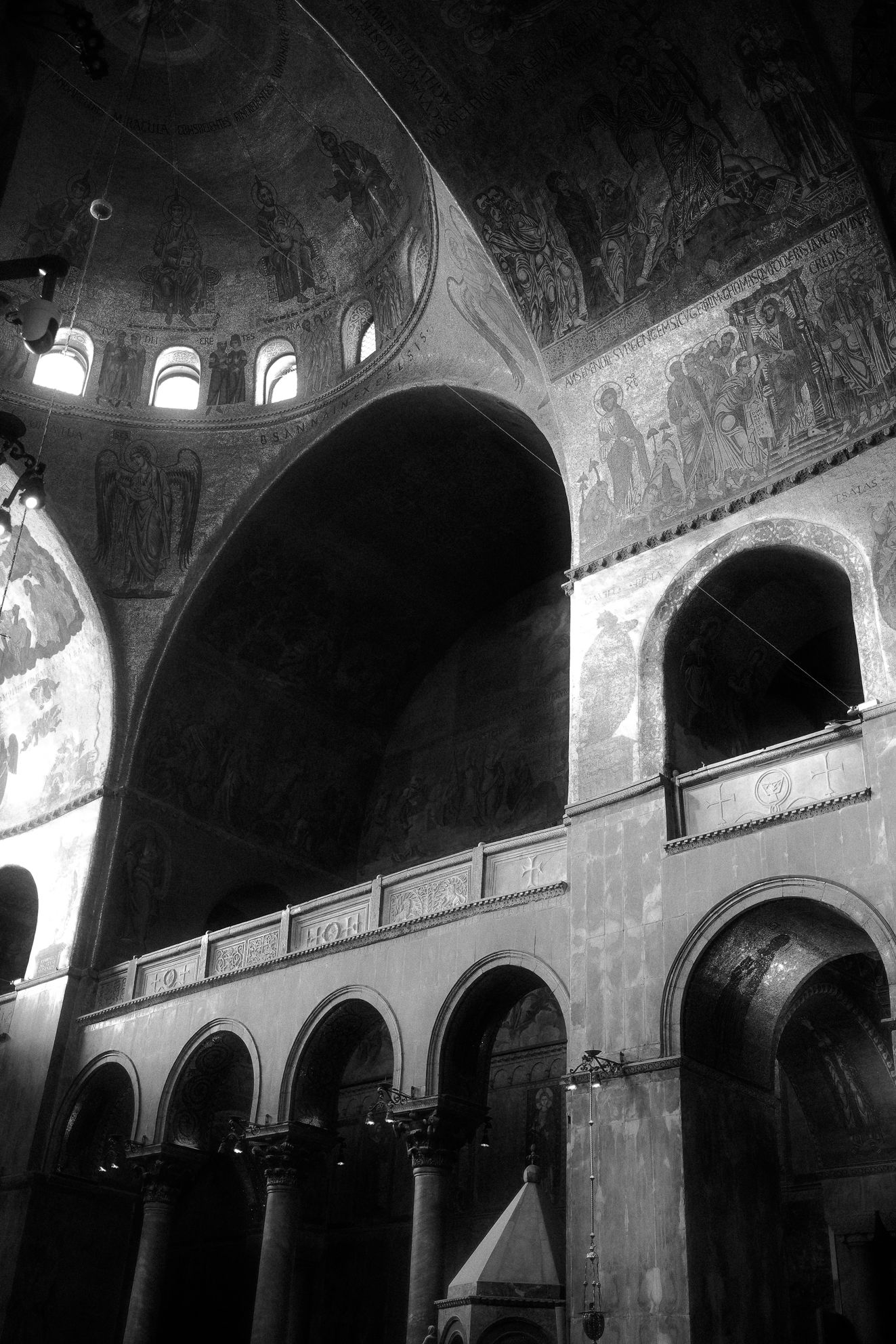 Black and white image of the Golden Mosaics of St. Mark’s Basilica in Venice – Photography by Rodrigo Baumgratz This evocative photograph by Rodrigo Baumgratz captures the glowing golden mosaics and Byzantine arches of St. Mark’s Basilica in Venice. The intricate frescoes and gilded domes rise with sacred intensity, showcasing a balance of grandeur and intimacy within one of the world’s most iconic cathedrals. The warm tones, layered textures, and dramatic lighting highlight both architectural mastery and spiritual symbolism. Perfect for portfolios in artistic architectural photography, sacred spaces, Venetian heritage, and fine art documentation of historic landmarks.