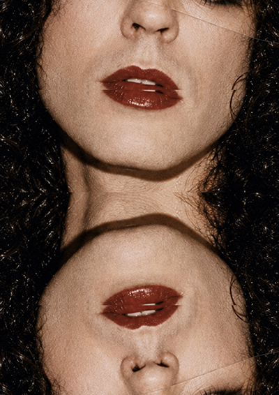 Symmetrical portrait collage built from repeated facial fragments, dark hair and red lips, part of an experimental art direction and graphic design series for a creative director portfolio.